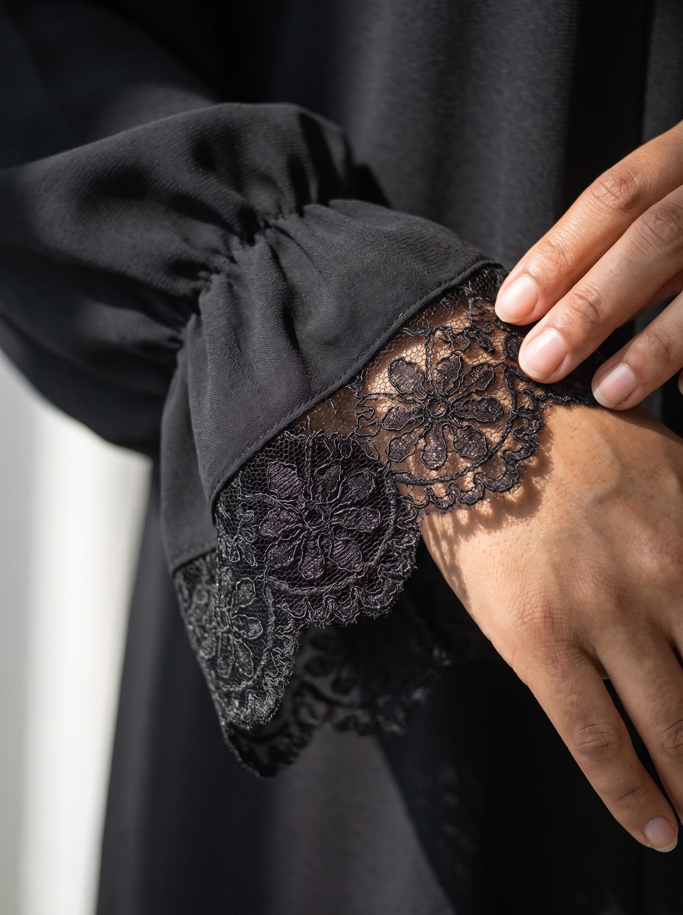 Macro detail of scalloped lace cuff